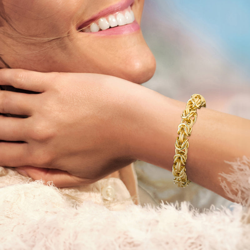 Gold Byzantine chain bracelet worn on wrist with oval clasp