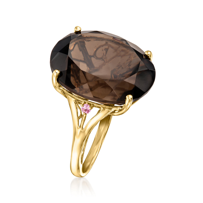 Side view of smoky quartz oval ring, yellow gold prongs with pink sapphire accents