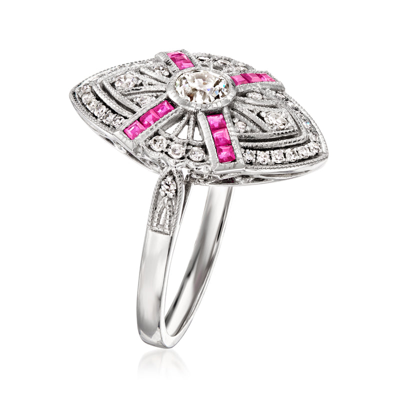 Platinum ring with round diamond center, pink ruby side stones, and ornate halo