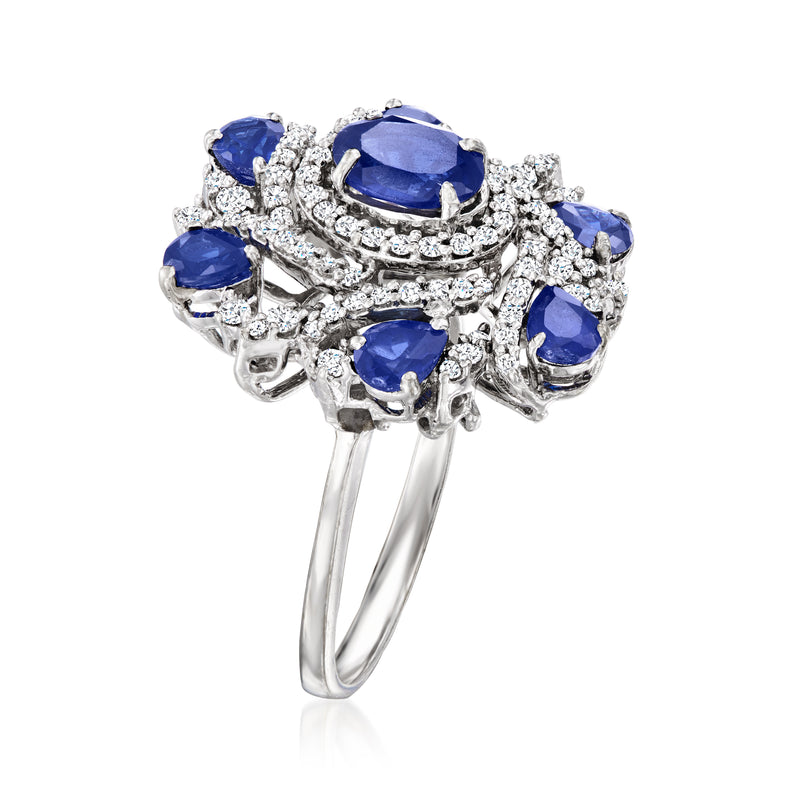 White gold cluster ring with blue oval sapphires and sparkling diamond halo detail