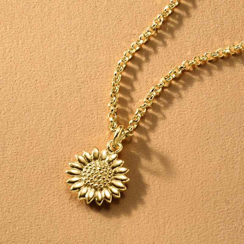 Gold-tone sunflower pendant necklace with textured sunflower charm and curb chain