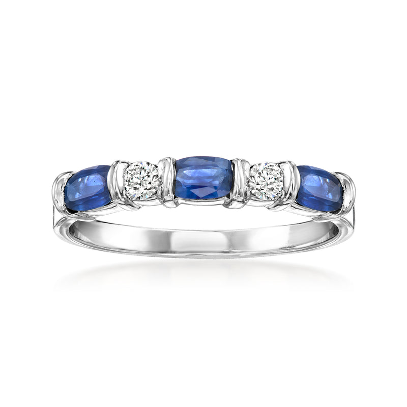 14kt white gold ring with blue sapphire center and round diamonds along the band