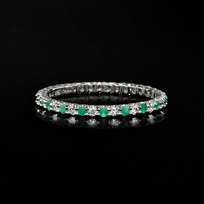 Sterling silver eternity band with green and clear stones, slim polished profile