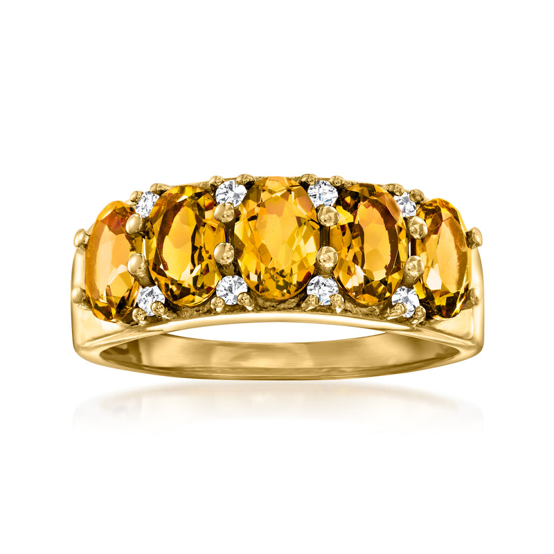 Gold ring with three oval citrine stones and small white zircon accents