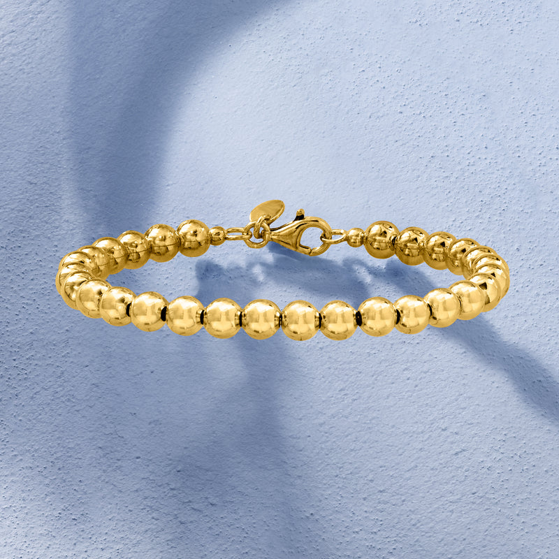 Gold bead bracelet with lobster clasp and evenly spaced round beads