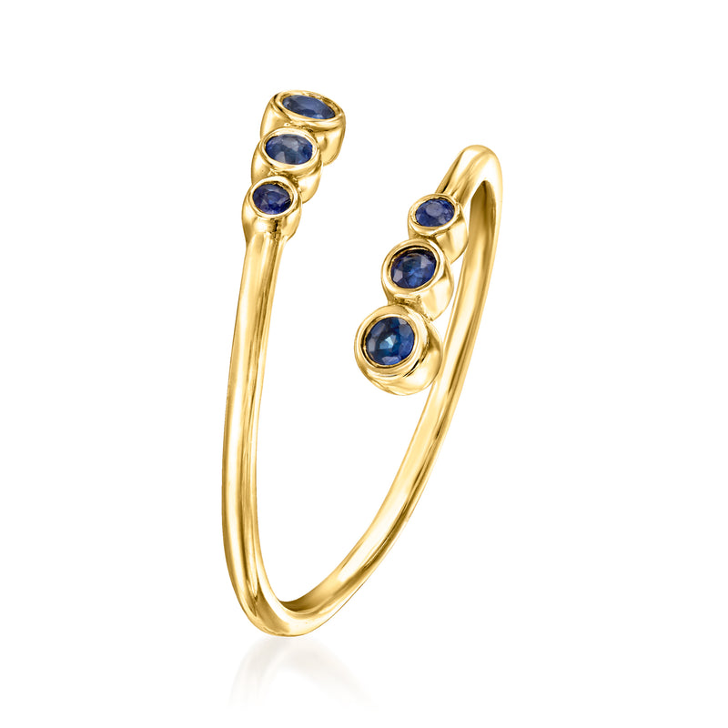 10kt yellow gold bypass ring with three blue round sapphires, curved profile