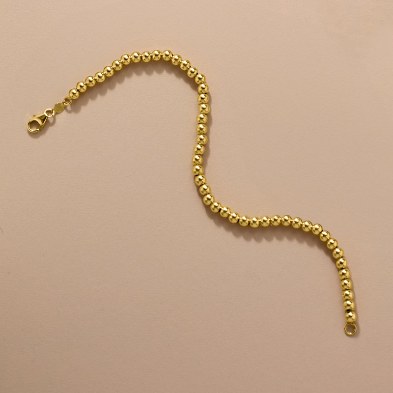 Yellow gold bead bracelet chain with round bead links and small loop end