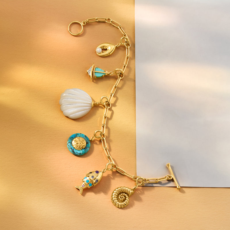 Gold charm bracelet featuring lobster claw charm with cultured pearl detail
