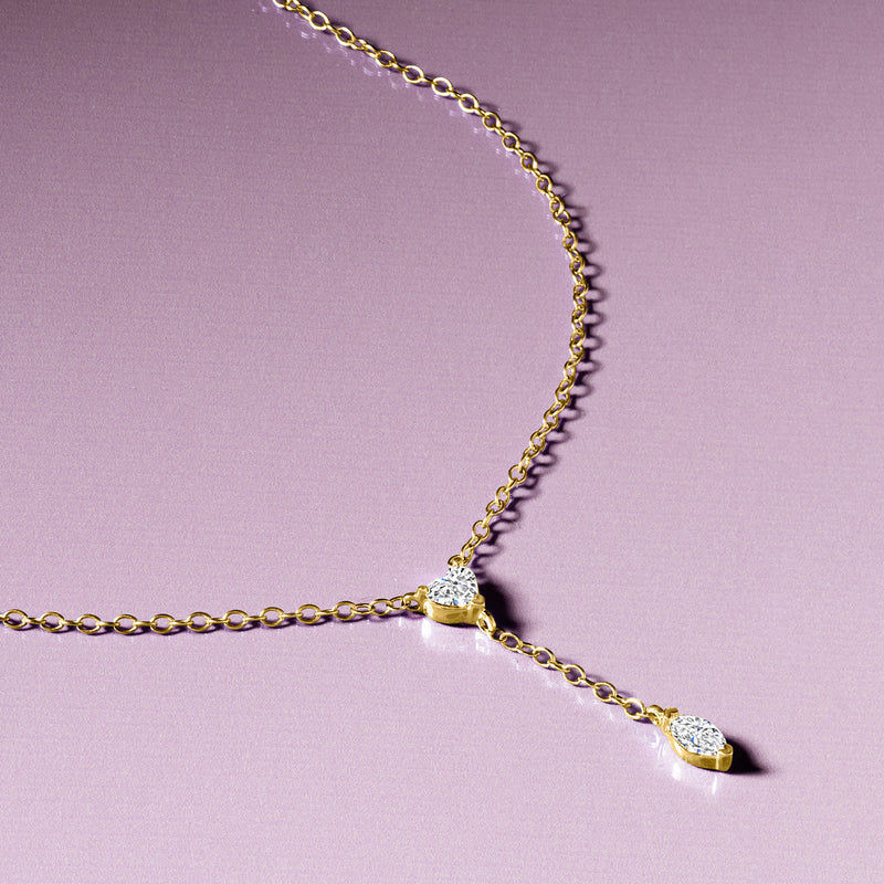 14kt yellow gold Y-necklace close-up with heart center and marquise diamond drop