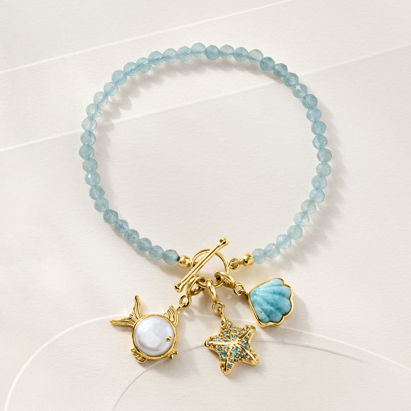 Starfish charm bracelet with blue beaded band and gold-tone shell charms