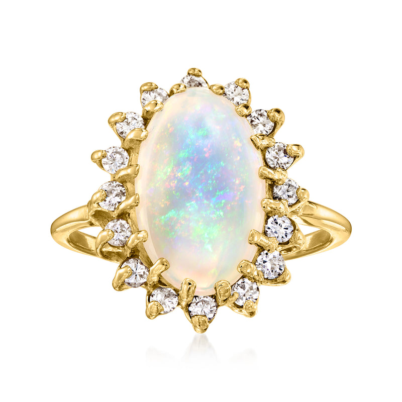 Oval opal gemstone ring with round diamond halo and 14kt yellow gold band