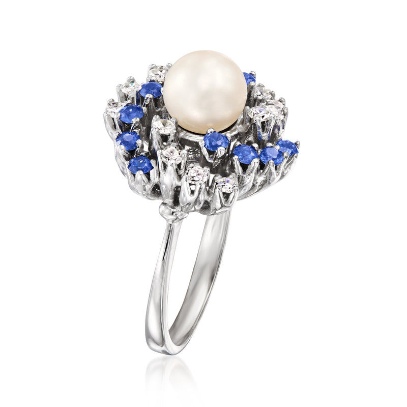 14kt white gold ring with round pearl center, blue sapphires, and clear diamond stones