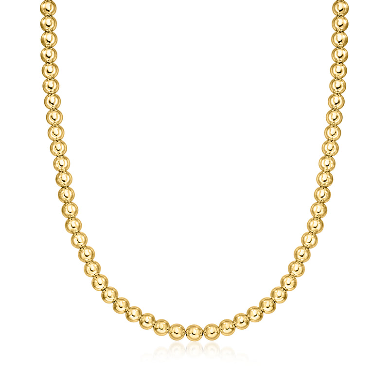 Gold bead necklace with small round beads in a continuous chain.