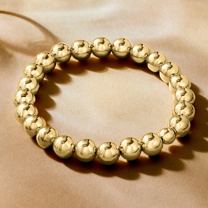 Gold-toned round bead stretch bracelet viewed from above