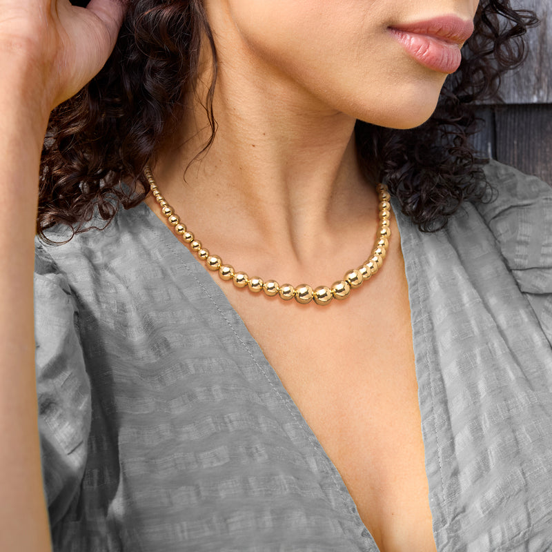 Gold bead necklace on model: graduated round beads, Italian 4–10mm style