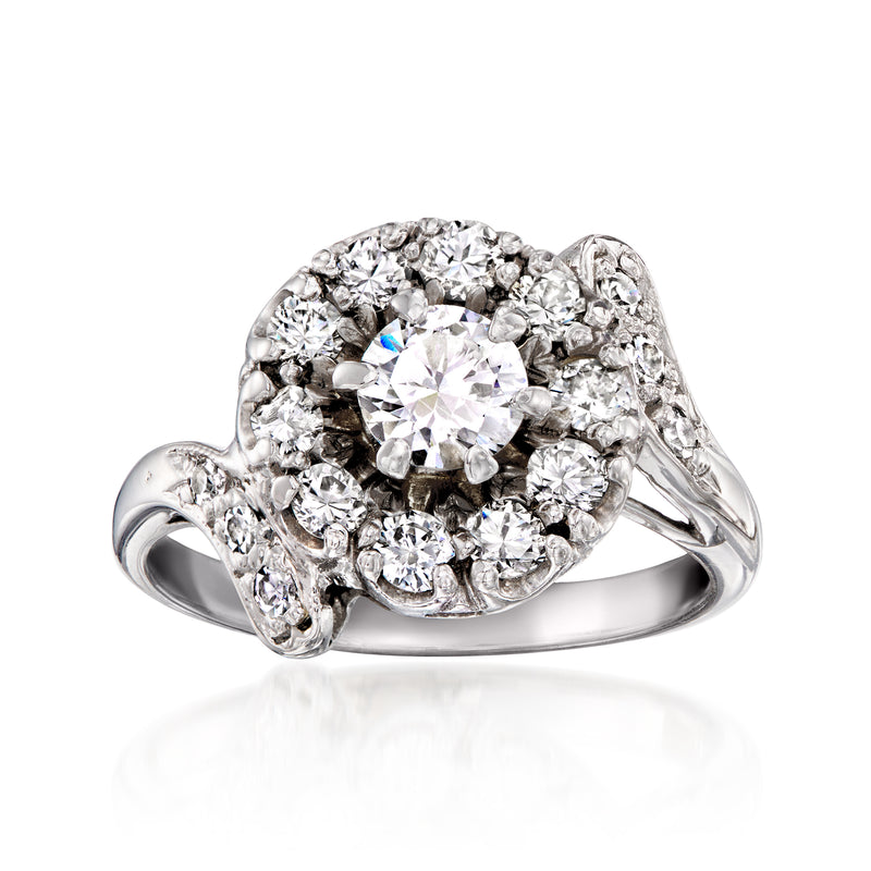Vintage diamond cluster ring in white gold with round center stone and halo