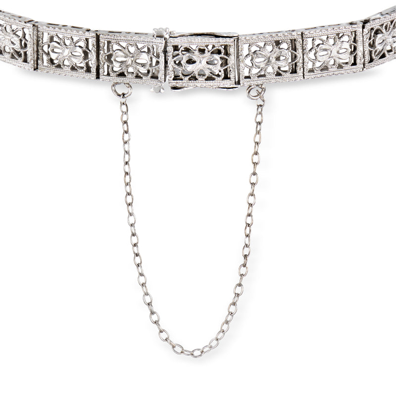 White gold filigree bracelet with blue sapphire panel and diamond accents, hinged clasp