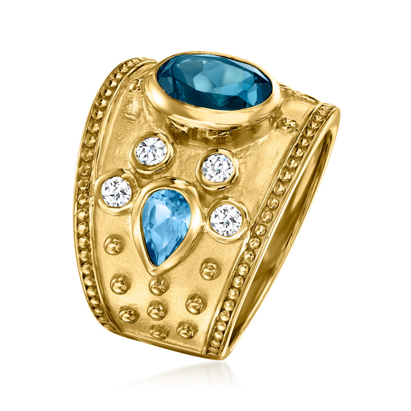 Gold-tone gemstone ring with oval blue top stone and teardrop blue stones plus clear accents