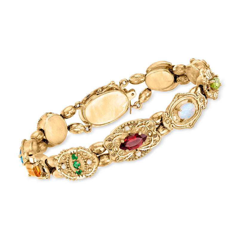 14kt yellow gold charm bracelet with oval gemstones and ornate links, multicolor accents