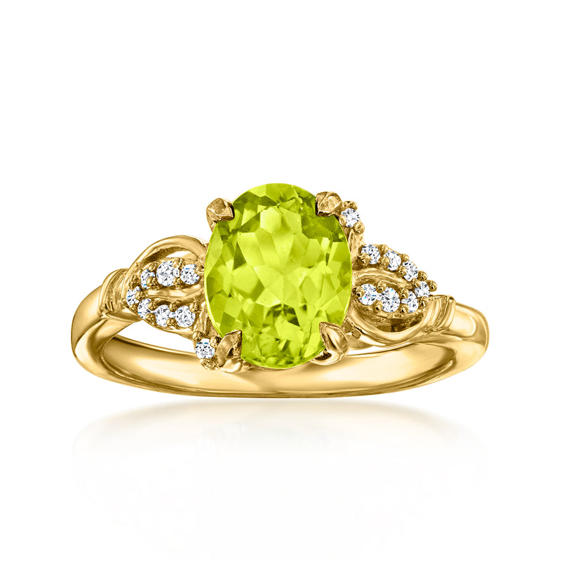 Gold ring with oval peridot-green gemstone and white zircon accents, three-stone style