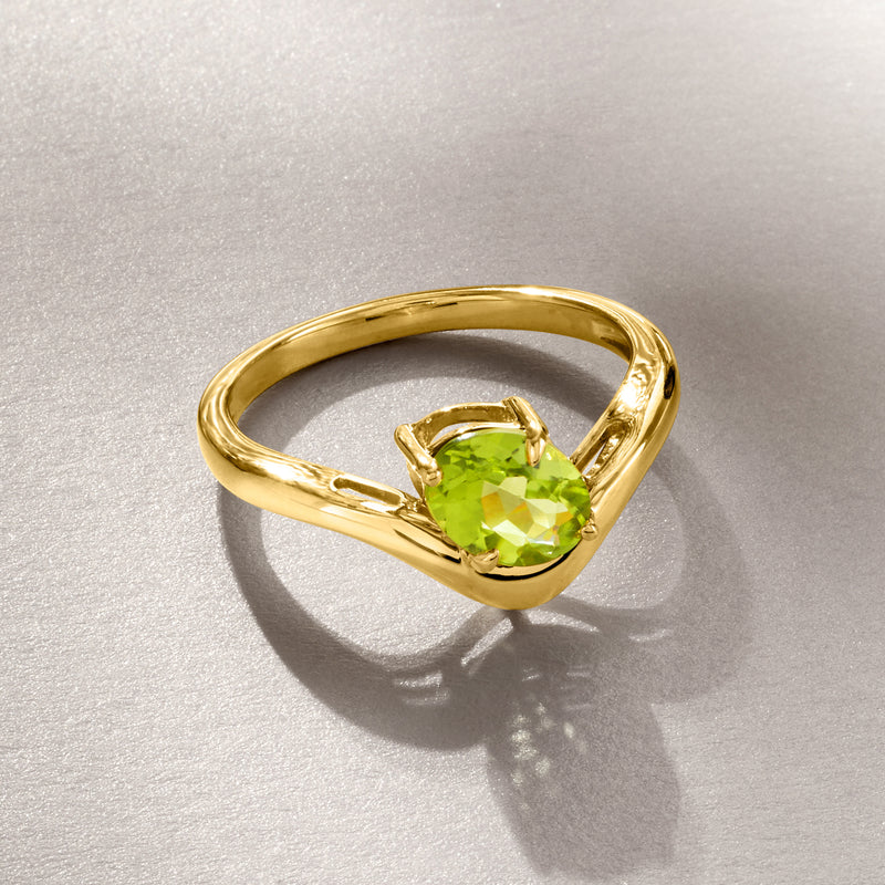 Curved gold ring with oval peridot green stone set in an open frame