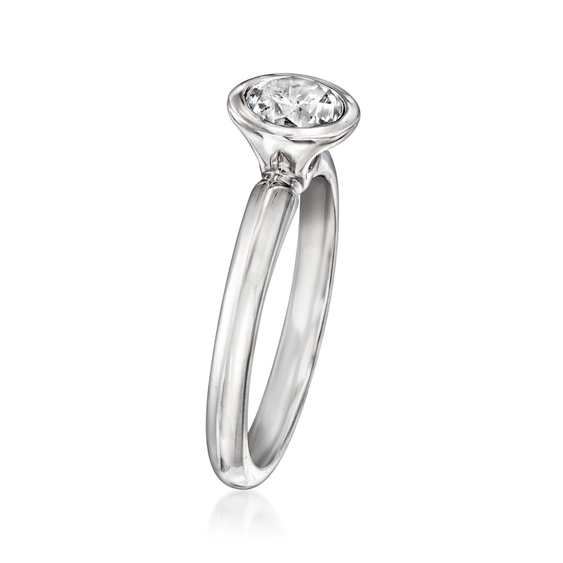 Round diamond in bezel setting atop 14kt white gold band ring, side view