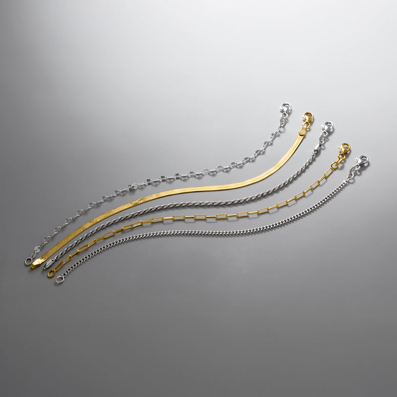 Mixed silver and gold chain bracelets displayed together with clasps visible