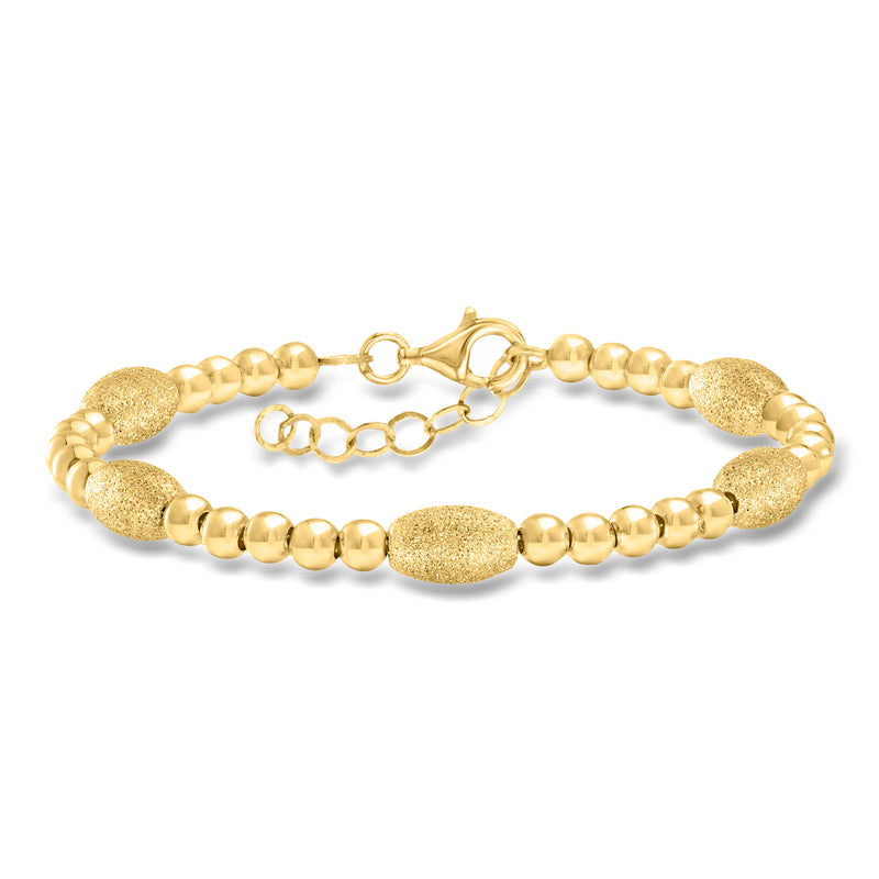 Gold-tone bead bracelet with textured and polished oval and round beads, clasp at center