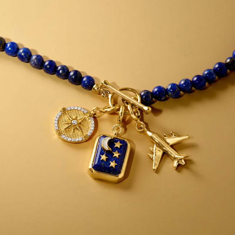 Airplane charm pendant in gold-tone with small plane figure on blue beaded necklace