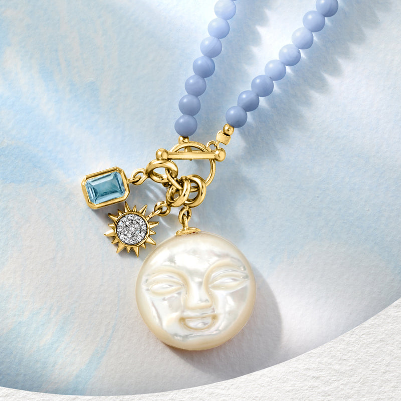 Gold necklace with blue bead strand and sun charm with round diamond halo