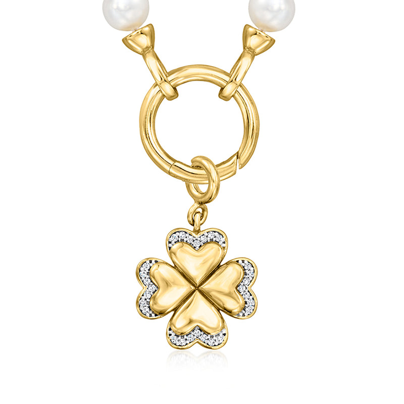 Gold four-leaf clover charm with heart-shaped center and sparkling stone border