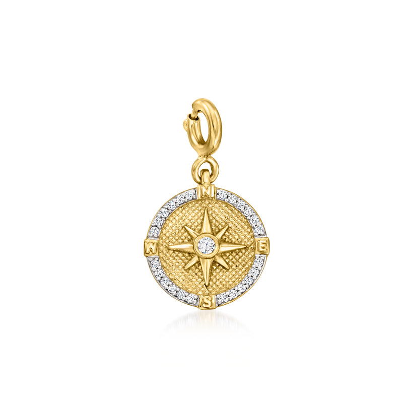 Gold compass charm with starburst center and diamond-look accents, round pendant
