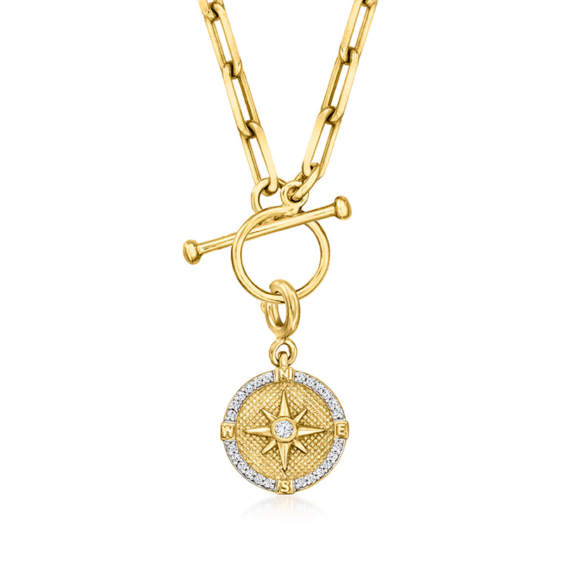 Round gold compass charm pendant with starburst design and diamond-look rim
