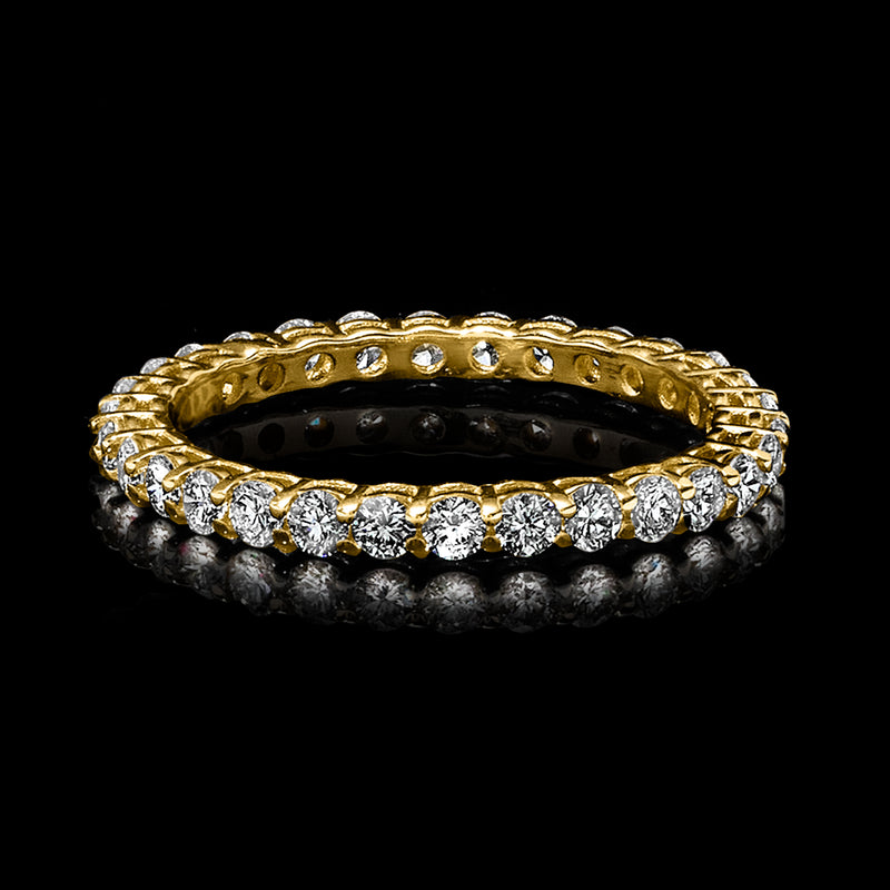 Yellow gold diamond eternity band with round stones and an open gallery interior