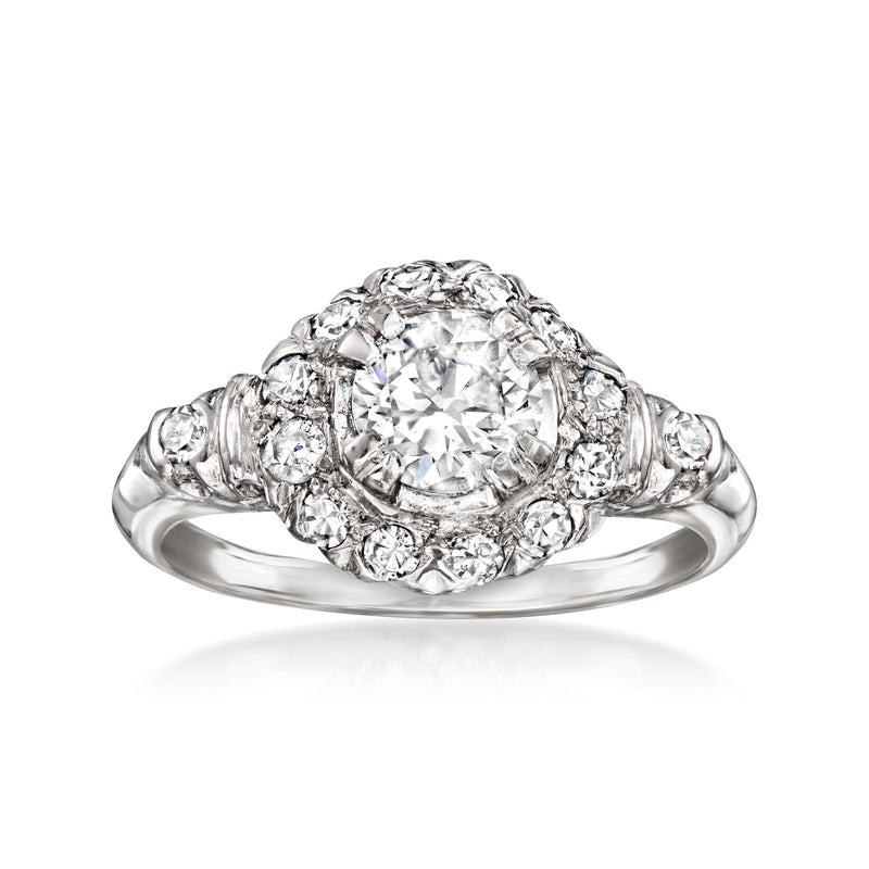 Platinum vintage diamond cluster ring with large center stone and small side diamonds