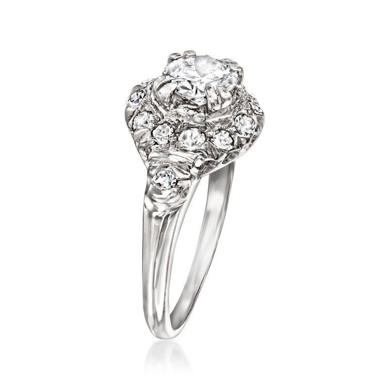 Platinum vintage diamond cluster ring angled view with prong-set round center stone