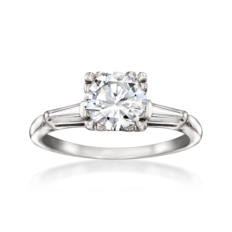 Diamond ring with round center stone and bar prongs on smooth white metal band