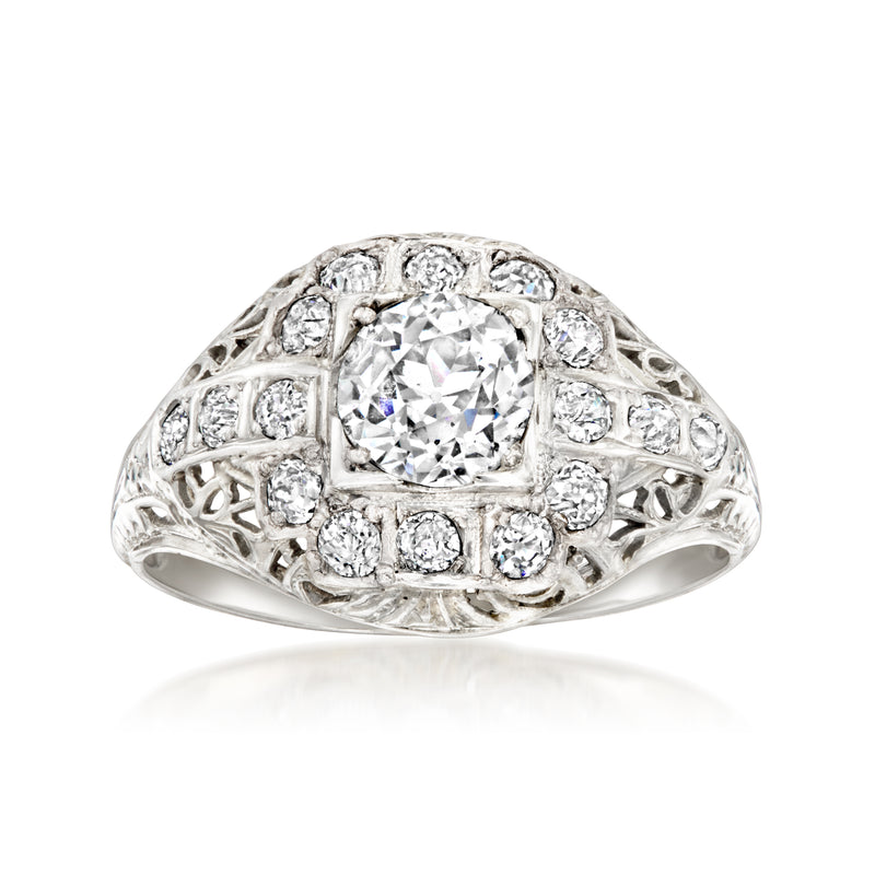 Vintage white gold diamond filigree ring with oval center stone and round accents