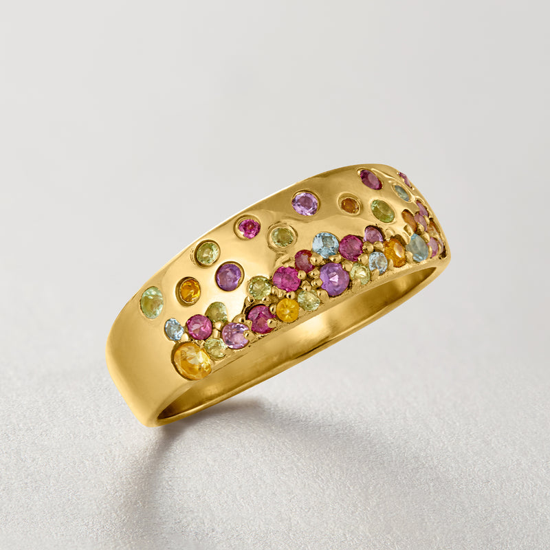 Gold-tone ring with multicolor scattered gemstones across the top of the band