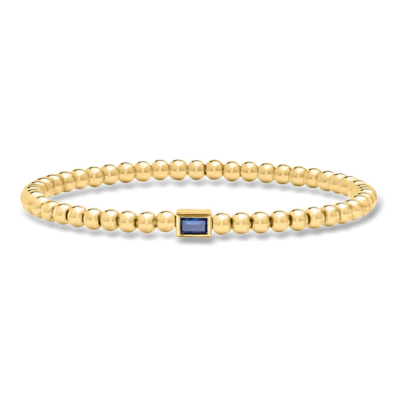 Gold bead stretch bracelet with blue square gemstone centerpiece