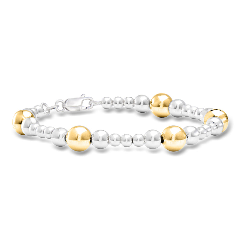 Graduated sterling silver bead bracelet with 18kt gold over silver round accents