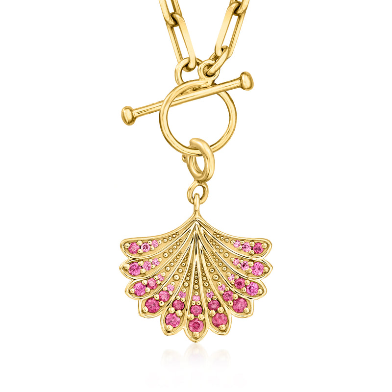Gold bail and hanging loop detail with pink fan seashell charm and gem accents.