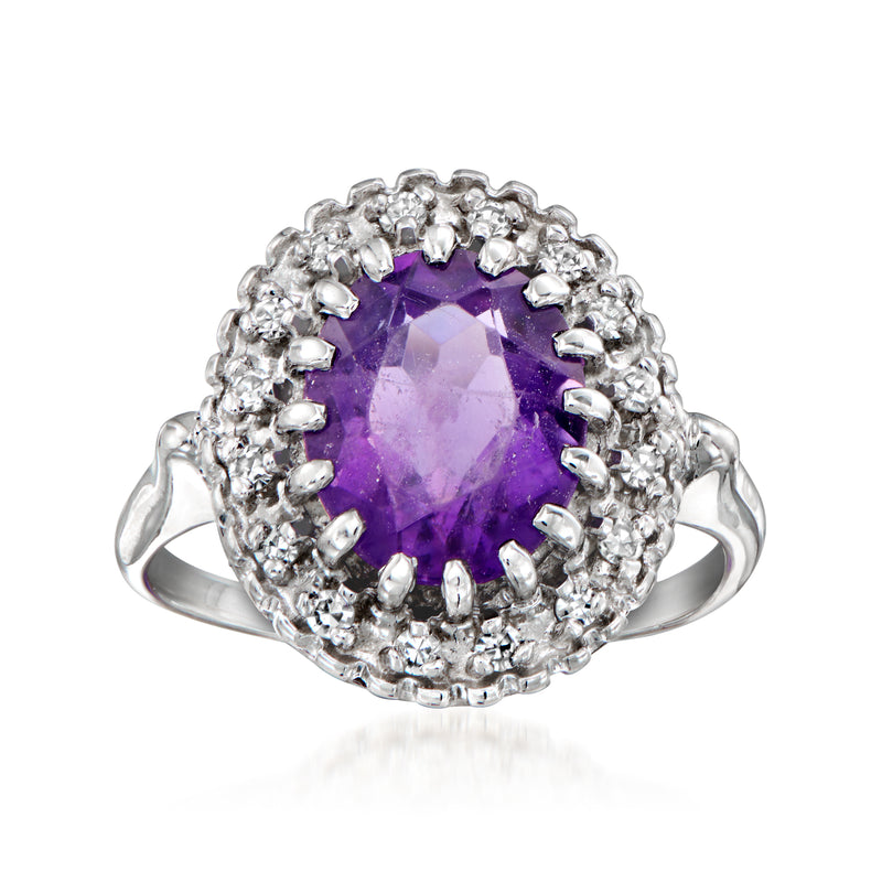 Vintage amethyst ring with oval purple gemstone, diamond halo, and white gold band