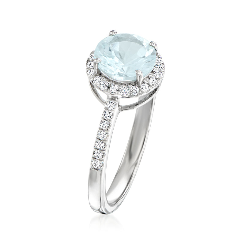 Platinum aquamarine ring with round center stone, diamond halo, and pave shank