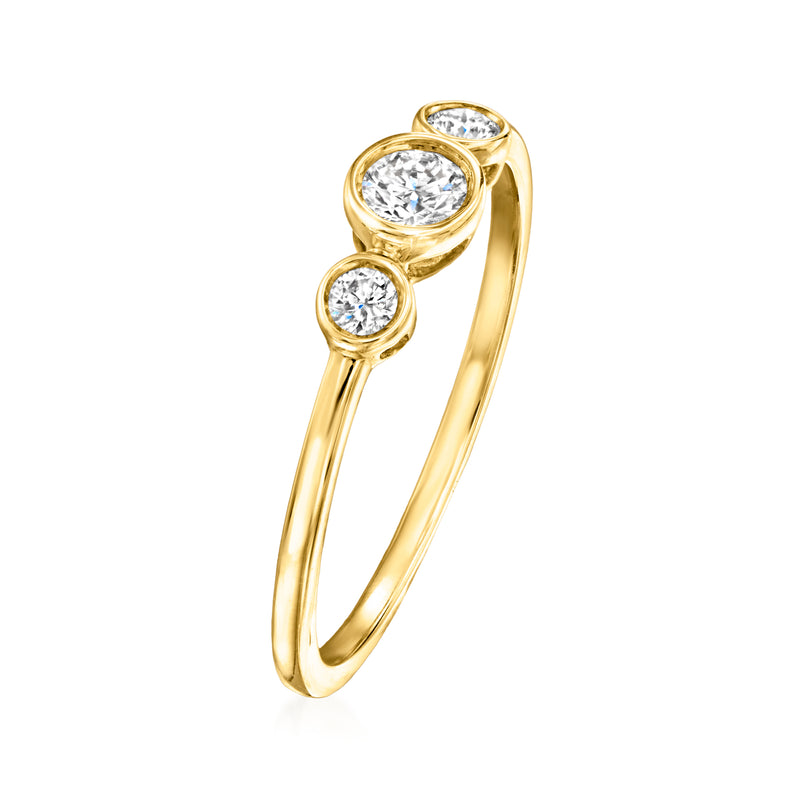 14kt yellow gold trio diamond ring with three round bezel-set stones in profile