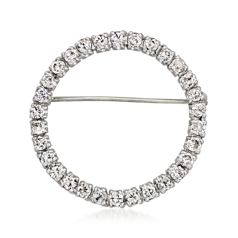 Platinum circular diamond pin with raised round stones and straight clasp pin stem