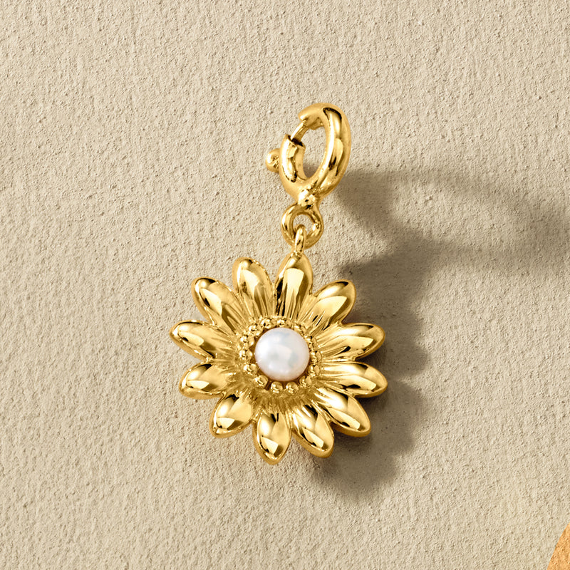 Gold sunflower charm with round white cultured pearl center on small hoop bail