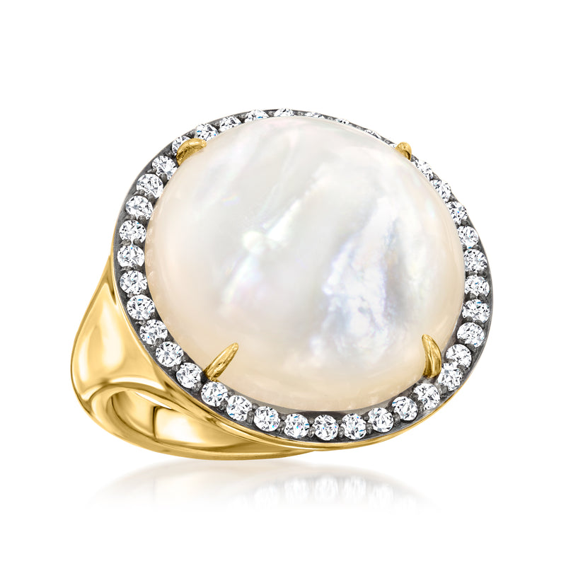 Gold-tone ring featuring oval mother-of-pearl gemstone and diamond halo