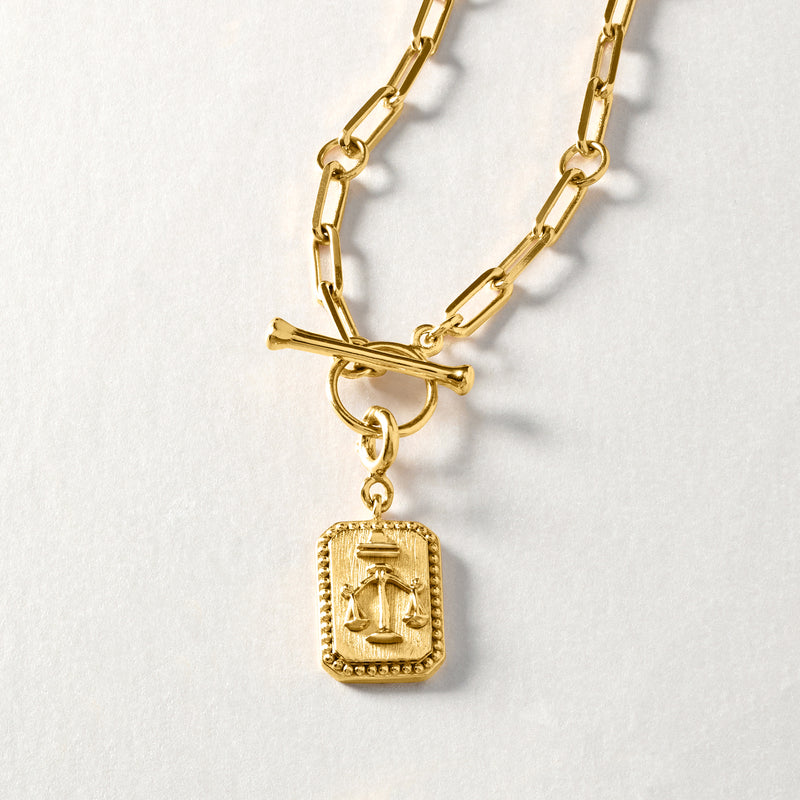 Zodiac charm pendant on gold chain, rectangular gold over sterling charm with bail