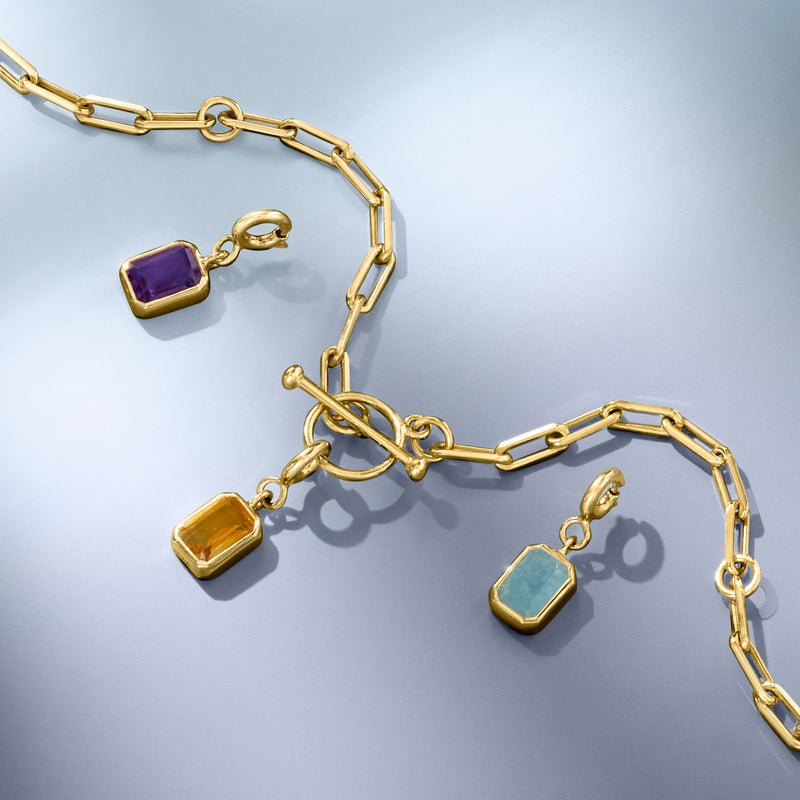 Gold chain necklace with small emerald-cut purple and yellow charm stones